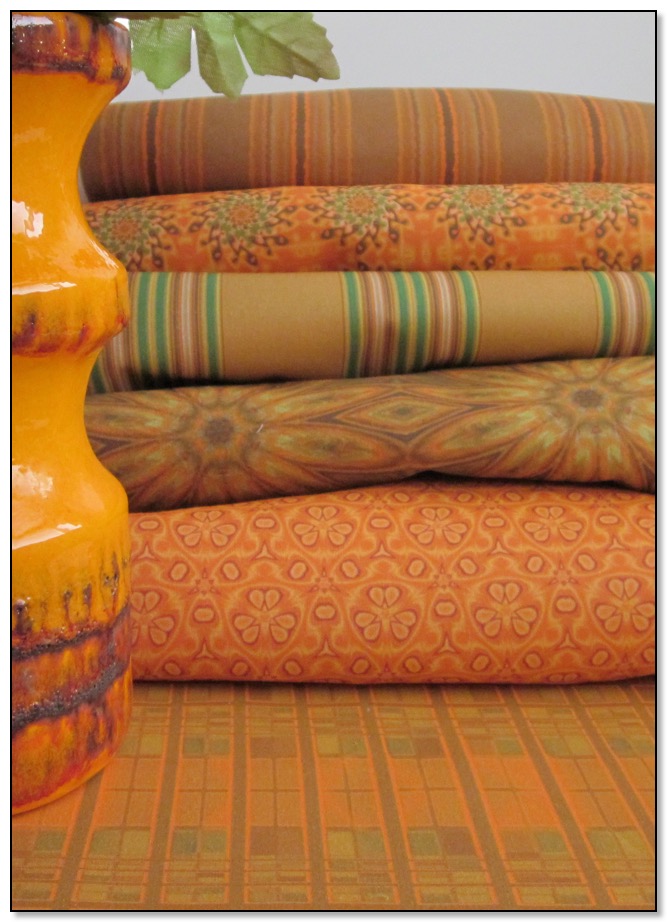 A stack of orange fabric from the Cozy Collection by Gingezel